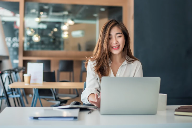 Home 28 Charming asian businesswoman sitting working on laptop