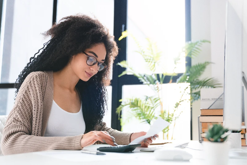 Home 23 Young woman using a mortgage calculator