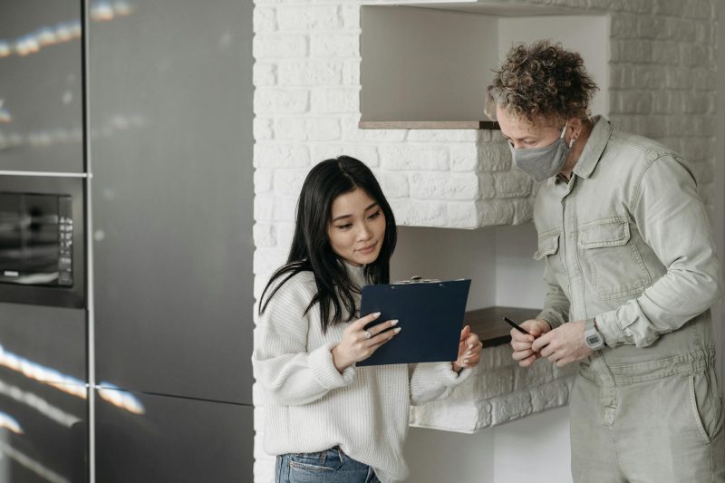 Home 4 Masked courier and woman interacting indoors