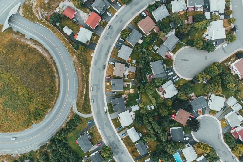 Home 2 Aerial view of a suburban neighborhood with curved roads