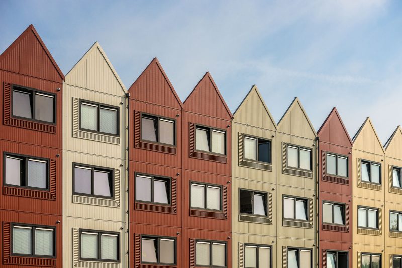 Home 10 A vibrant row of gableroofed residential buildings with meta 1782838821